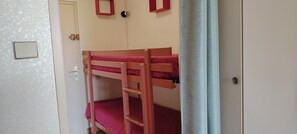 A bunk bed with a ladder, a door, and a light switch on the wall. - STUDIO CABIN 4 PERSONS (Agde)
