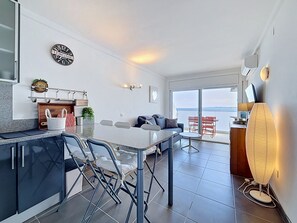 Eine moderne Küche mit Essbereich, einer Couch und Meerblick.