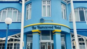 A blue building with a sign reading 'The Humewood Hotel'.