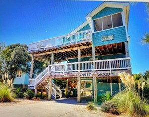 A two-story building with a balcony, a staircase, and a sign that reads 'DRIFTWOOD.' - Ocean Sands 4 Bedroom Private Pool In Culdesac Walk to Beach! The Drift - Woods (COROLLA)