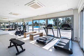 A modern gym with treadmills, stationary bikes, and weight machines. - Luxury Sea, Pool & Mountain View Apt near La Cala (Mijas Costa)