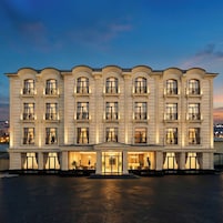 A multi-story hotel with a symmetrical facade, large windows, and a central entrance.