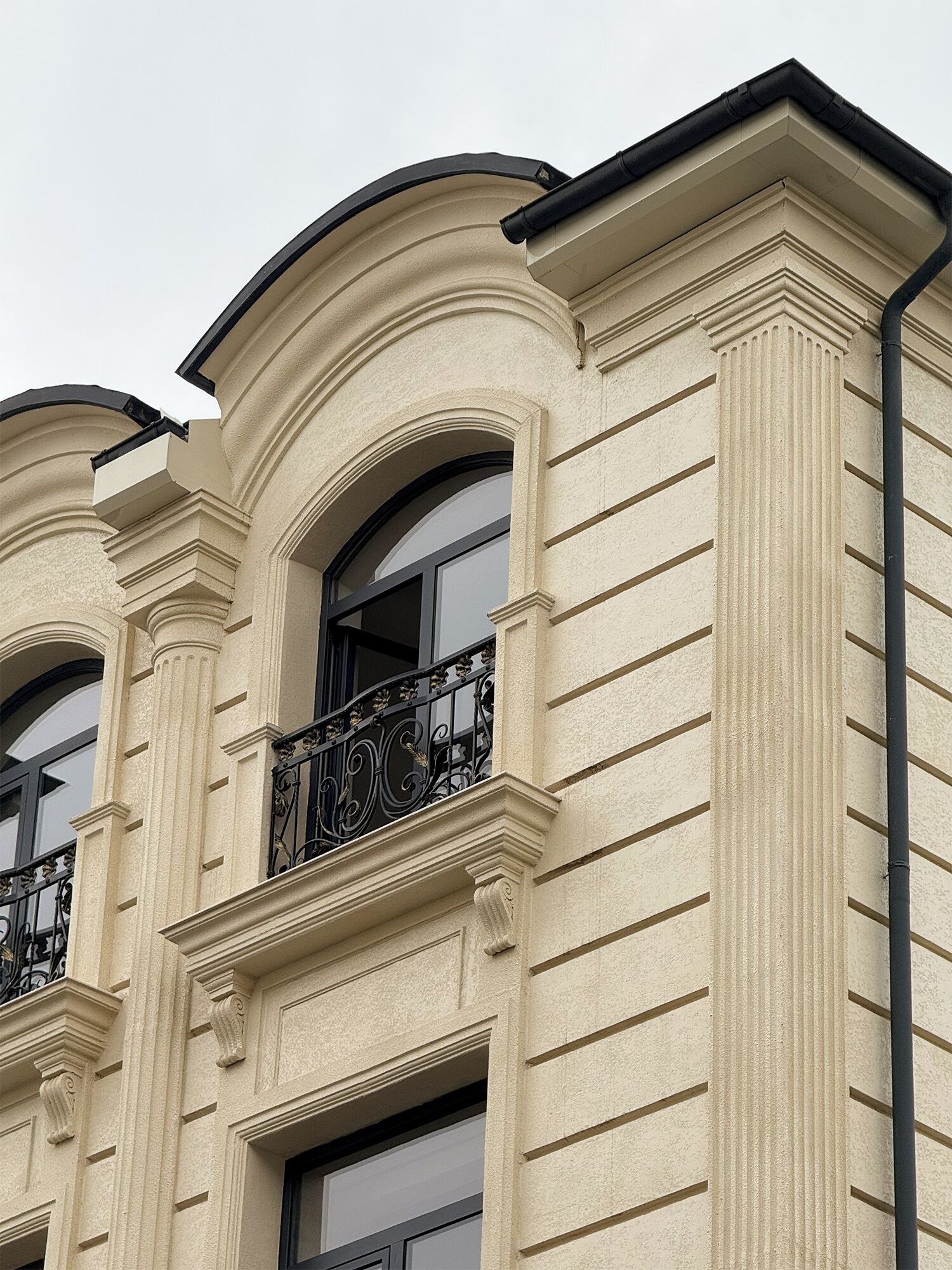 A building with classical architectural style, featuring arched windows and decorative moldings.