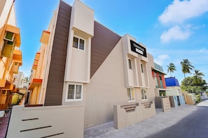 A modern building with a sign reading 'TOWNHOUSE.' - Classic Saibaba Colony Bus Terminal (Coimbatore)