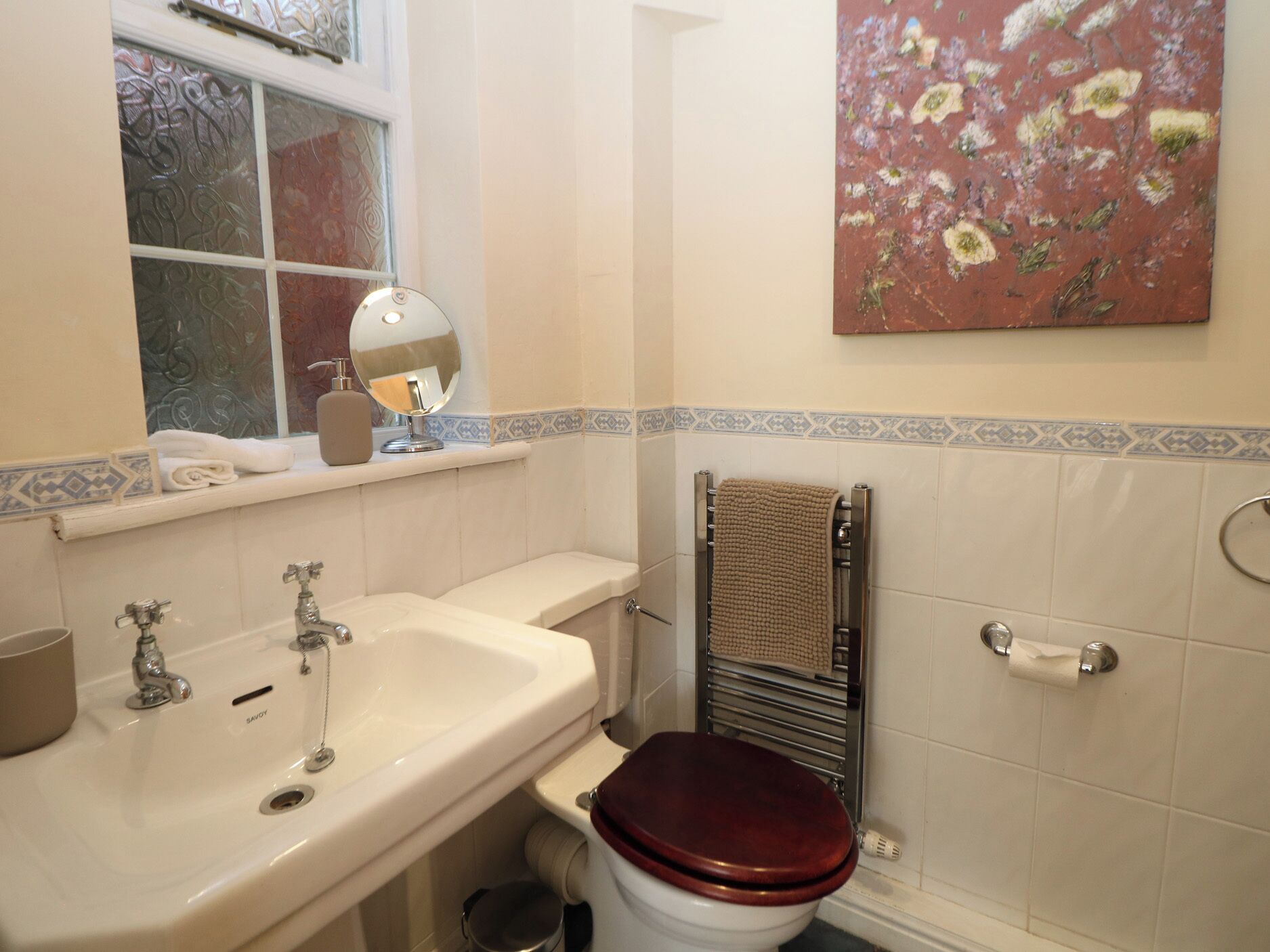 Un bany amb un lavabo, un mirall i un vàter.