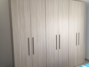 A large wardrobe with multiple doors and handles. - SA MARINA HOUSE #3. Cozy house for families with children, youth and animal (Sassari)