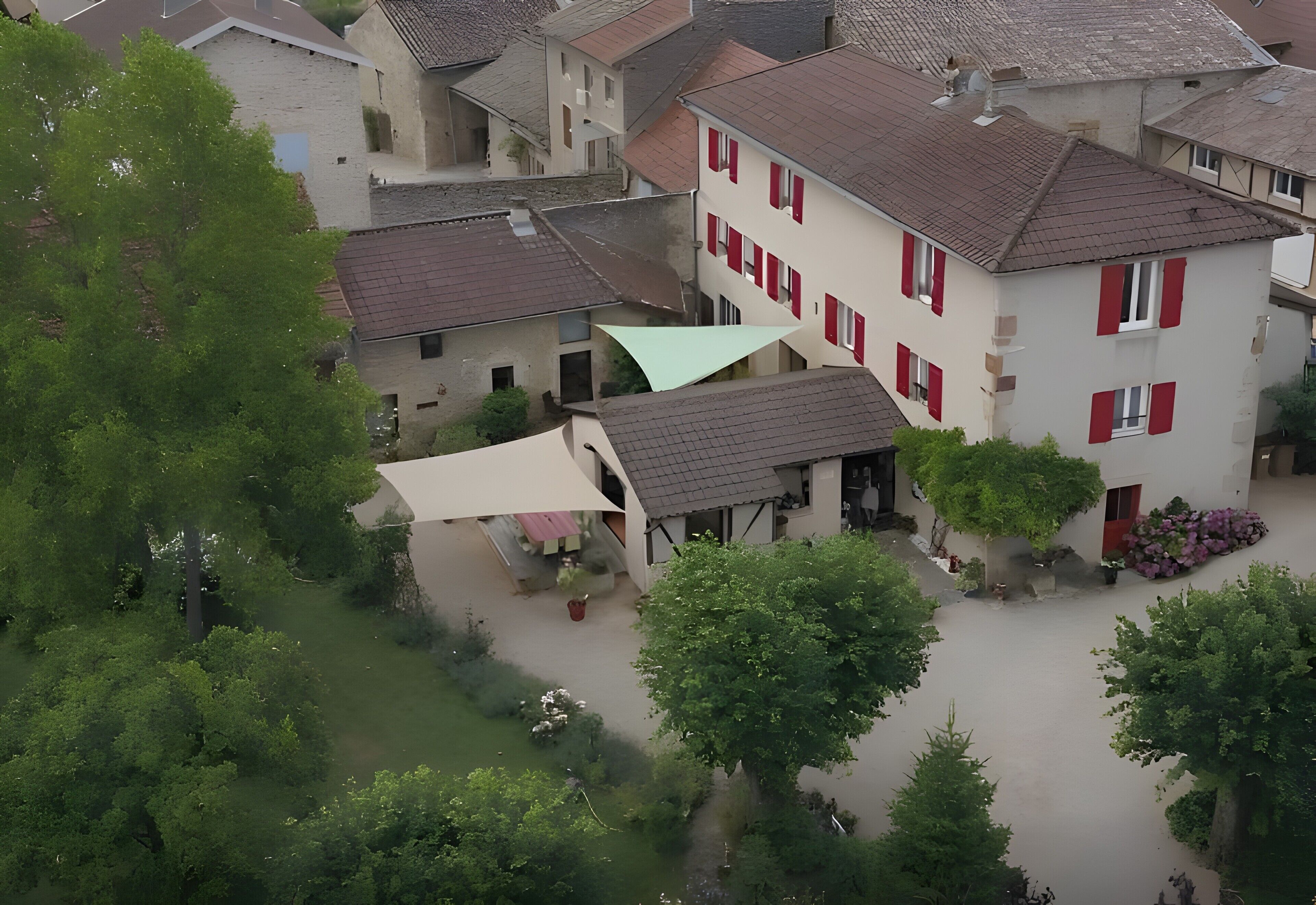 Un quartier résidentiel avec des maisons, des arbres et un grand parasol.
