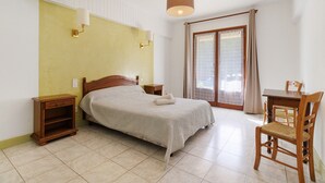 A bedroom with a bed, bedside tables, a desk, and a chair. - Guest Room 2 with Pool (Saint-Pompont)