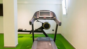 A treadmill in a room with green carpet and white walls. - In a Residence, Air-conditioned, With Terrace (Marone)