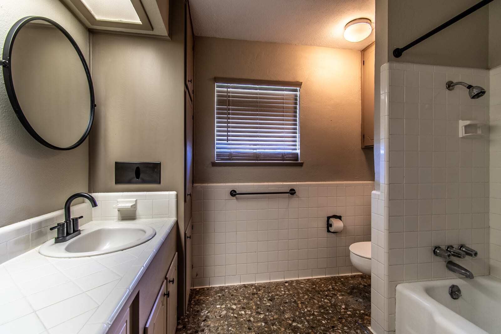 A bathroom with a sink, toilet, and shower.