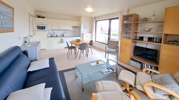 A modern apartment with a living room, dining area, kitchen, and a balcony with a view. - Cozy Apartment Near the Dunes (Koksijde)
