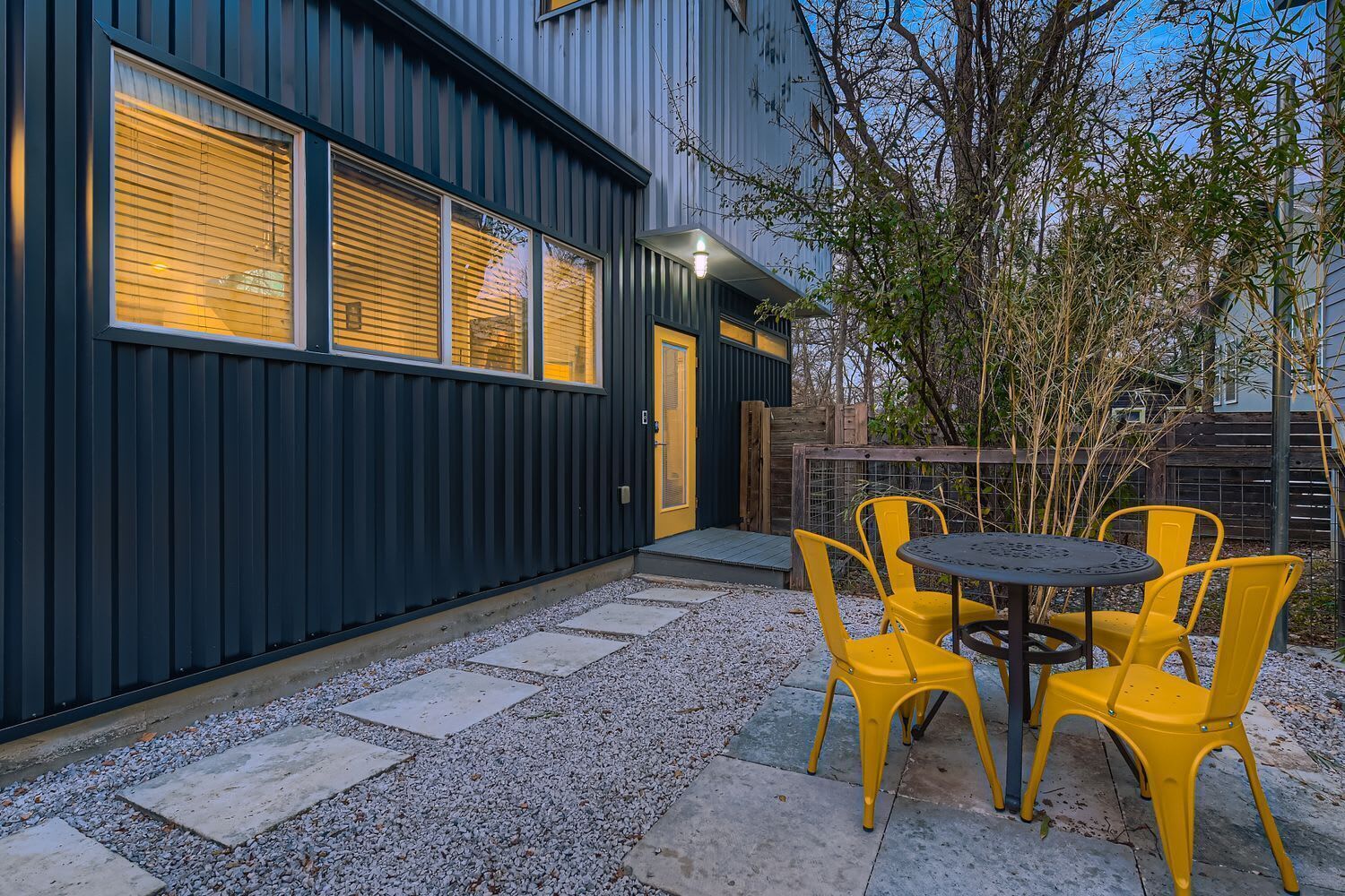 Modern exterior with illuminated entryway and private access to the home.