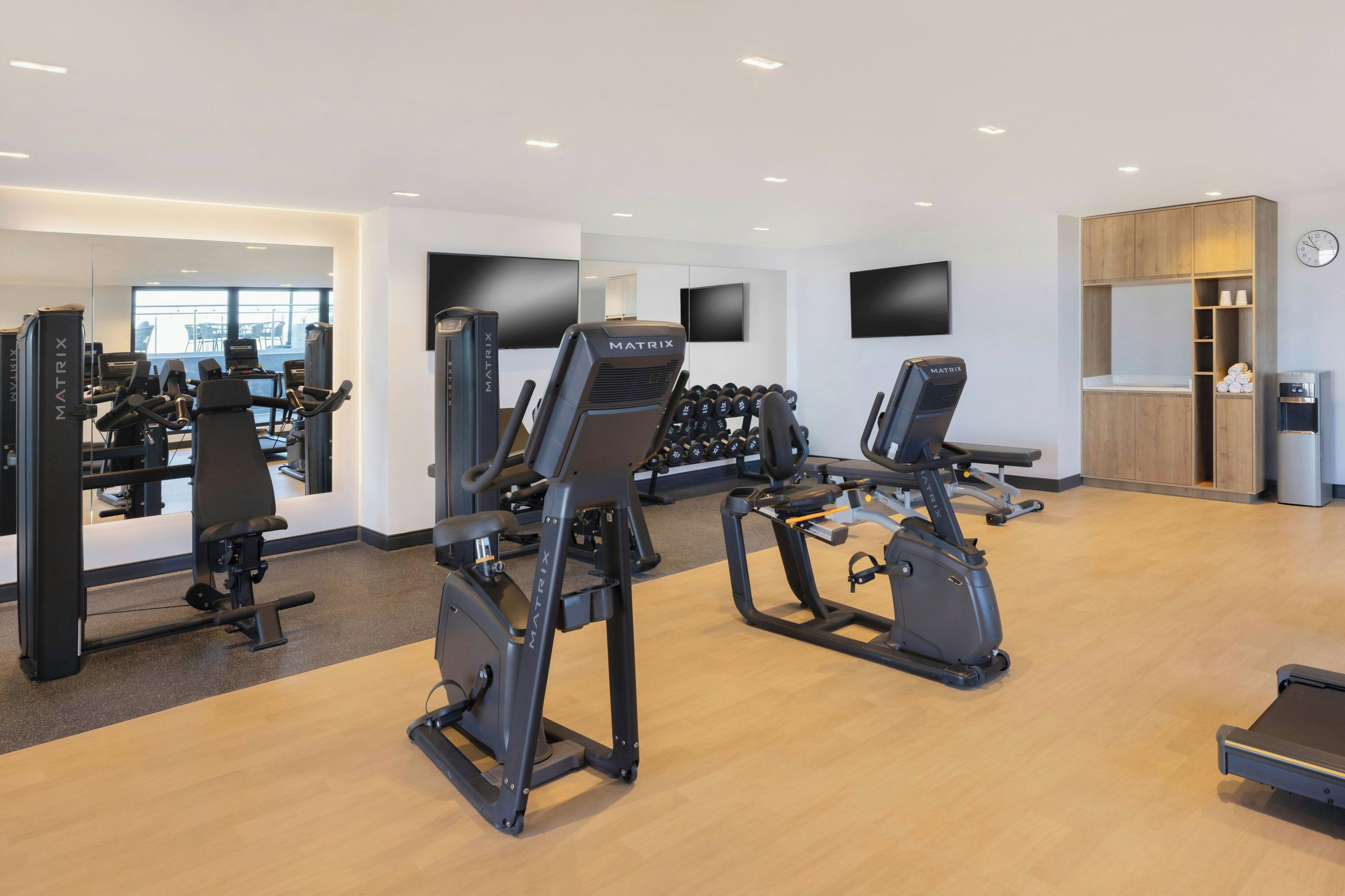 A gym with treadmills, elliptical machines, and weight machines.