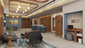 A modern reception area with a reception desk, seating, and a 'Quick Print' service sign. - Courtyard by Marriott Torreon (Torreon)