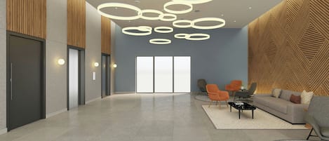 A spacious lobby with a modern design, featuring a large seating area, a reception desk, and a patterned wall.