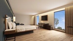 A modern hotel room with a bed, desk, chair, and large window. - Courtyard by Marriott Torreon (Torreon)