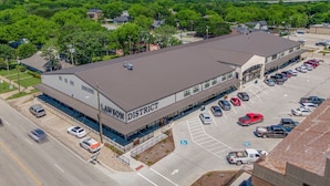 A large building with 'LAWSON DISTRICT' signage, a parking lot, and a clear view of the surrounding area.
