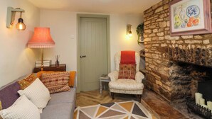 A cozy living room with a sofa, armchair, and a fireplace. - 29 Spring Street (Chipping Norton)