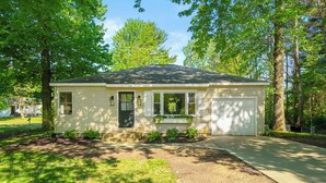A single-story house with a front porch, a garage, and a well-maintained lawn.
