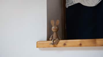 A wooden toy rabbit on a shelf.