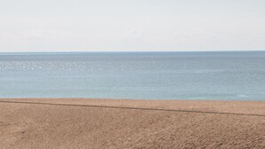 A beach with a clear sky and calm sea. - Flat 30 (Bridport)