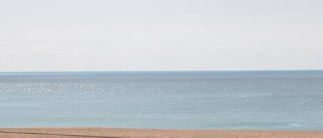 A beach with a clear sky and calm sea.