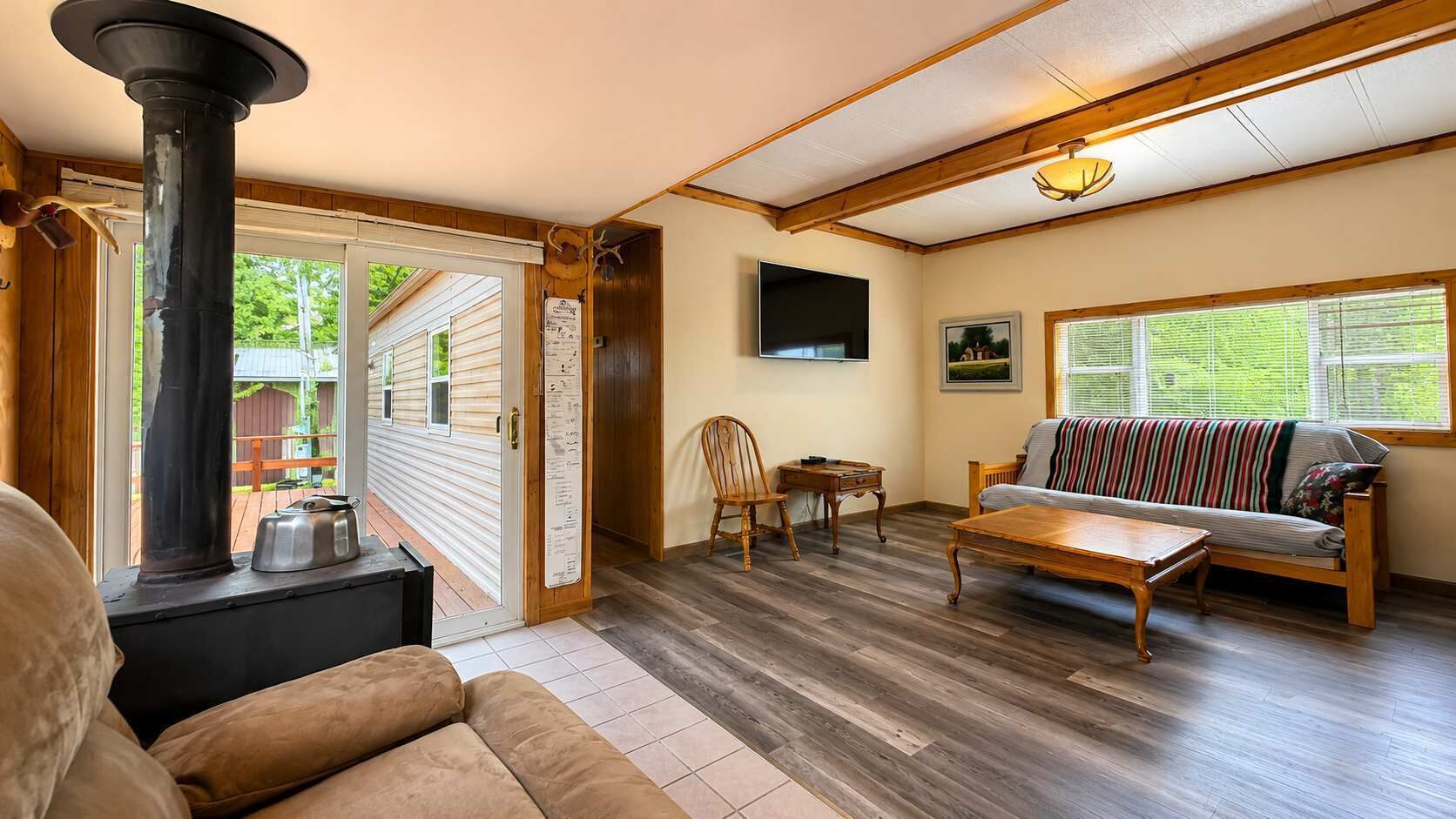 A cozy living room with a fireplace, a sofa, a coffee table, and a television.