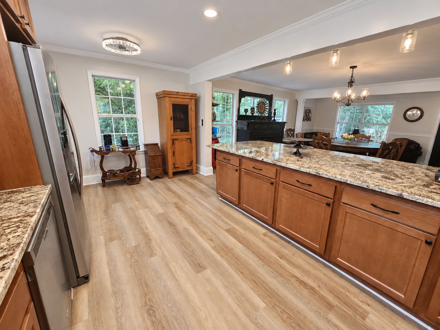 A kitchen with wooden cabinets, granite countertops, and a built-in oven.