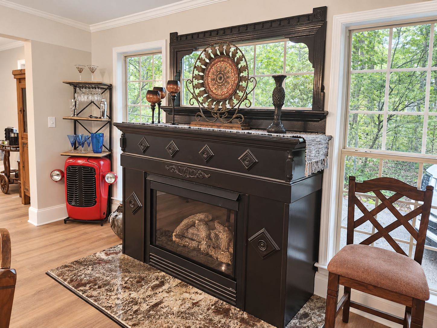 A room with a fireplace, a coffee table, and a chair.