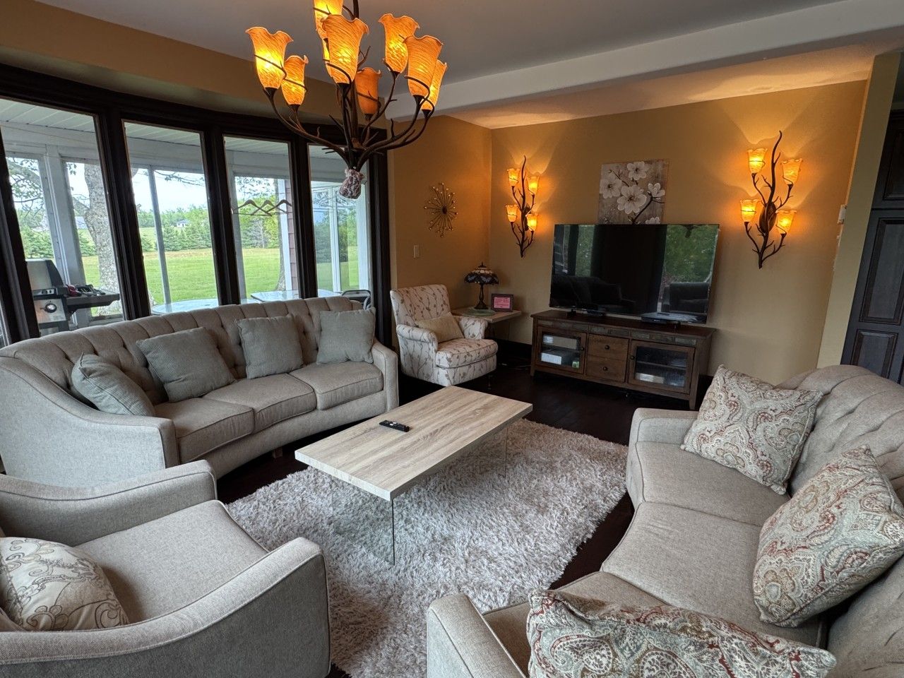 A living room with a sofa set, a coffee table, and a TV.