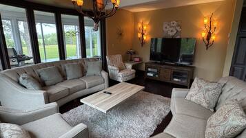 A living room with a sofa set, a coffee table, and a TV.