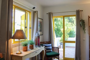 A room with a desk, lamp, chair, and potted plants. - Algarve escape in the heart of the prestigious Golden Triangle (Quarteira)