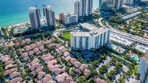 Un paysage urbain côtier avec de hauts immeubles, une marina et des quartiers résidentiels.
