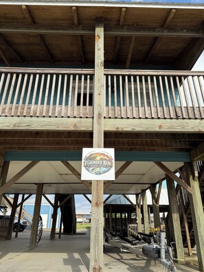 A wooden deck with a sign for 'Flounder Run' in Hackberry, Louisiana.
