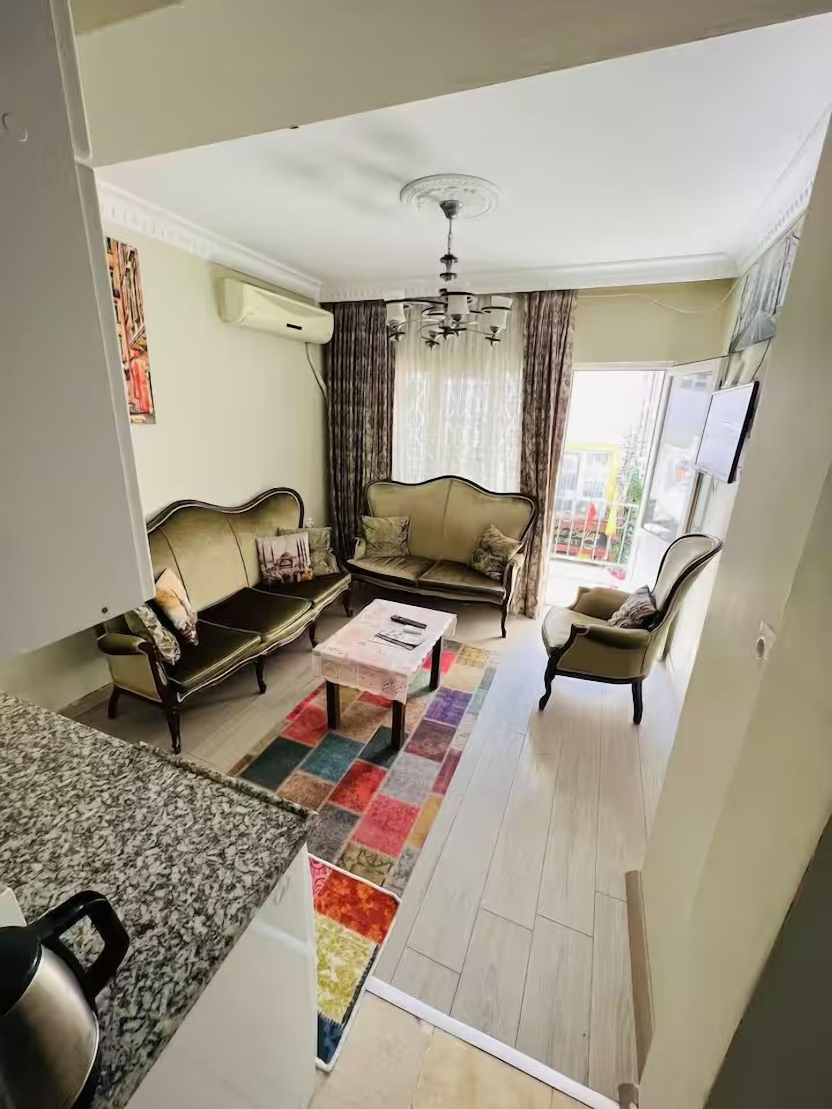 A living room with a sofa set, a coffee table, and a TV.
