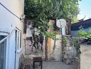A courtyard with a satellite dish, a small table, and a chair. - Santa Sophia Apart (İstanbul)