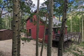 Ein rotes Gebäude mit einer Terrasse und einer Holztreppe.