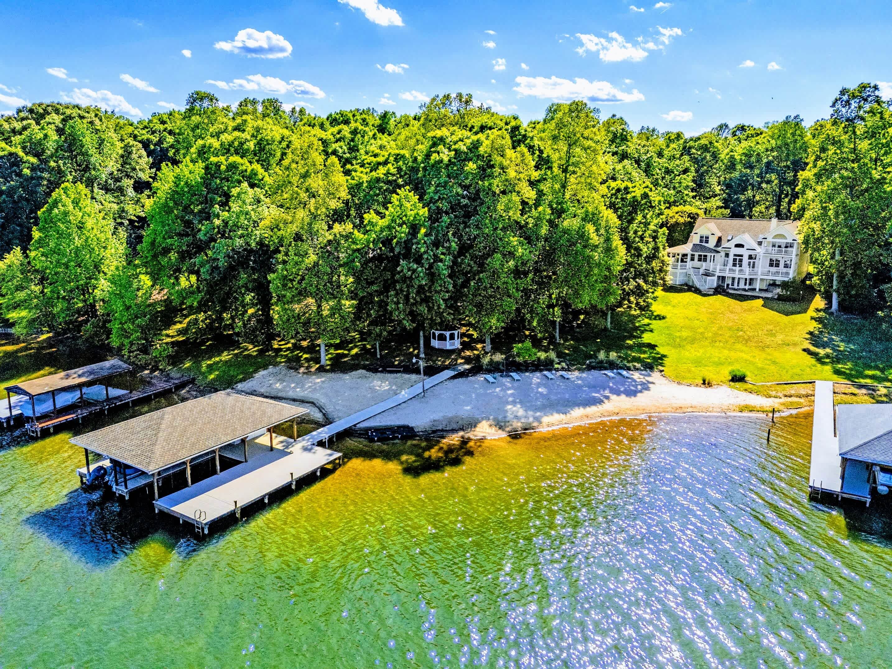 From Above - Wide aerial of the cove, the boat dock visible at the property line.