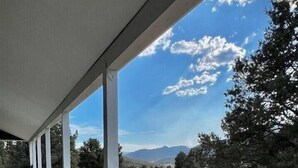 A covered outdoor area with a view of a natural landscape.