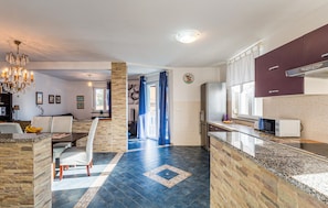 A modern kitchen with granite countertops, a built-in oven, and a microwave. - Beautiful home in Vodnjan (Vodnjan)