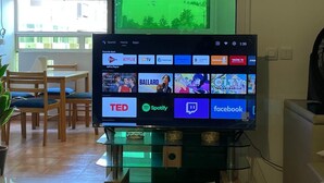 A television displaying various streaming services and a green screen in the background.