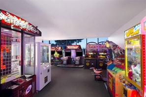 An indoor arcade with claw machines and various gaming machines. - Steps to Cavill Ave | Ocean View 2BR | 3 Pools (Surfers Paradise)
