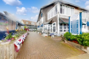 A brick building with a signboard listing various amenities like a Black Dog Premium Outlet, a restaurant, and a gift shop.