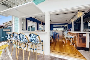 A bar area with wooden chairs and a counter.