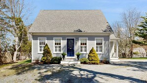 A single-story house with a blue door, white trim, and a gravel driveway. - Walk to Grays Beach, Near Shops & Boardwalk (Yarmouth)