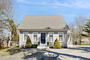 A single-story house with a blue door, white trim, and a gravel driveway. - Walk to Grays Beach, Near Shops & Boardwalk (Yarmouth)
