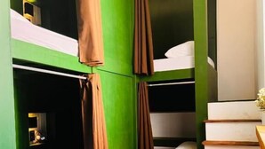 A room with bunk beds, a small table, and a staircase. - Cocos Hostel Rio (Rio de Janeiro)