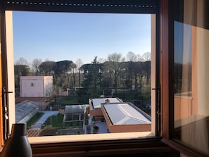 A view from a window overlooking a residential area with houses, trees, and a clear sky. - Pisa Centro a 10-minute walk, private parking, Wi-FI (Pisa)