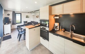 A compact kitchen with a Bosch oven, a coffee maker, and a sink. - Cozy home in Olonzac with heated swimming pool (Olonzac)