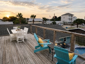 A wooden deck with outdoor furniture, a pool, and a view of residential buildings. - Perfect Family Home | Private Pool • Walk to Beach (Panama City Beach)